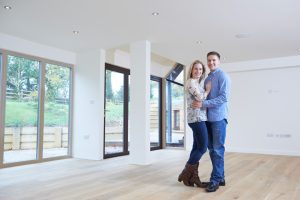 Portrait Of Happy Young Couple In New Home
