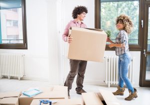 Happy young couple moving into their new house and communicating.