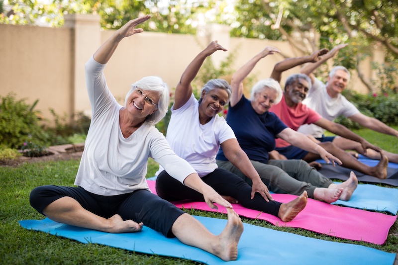Diverse group of smiling seniors doing yoga