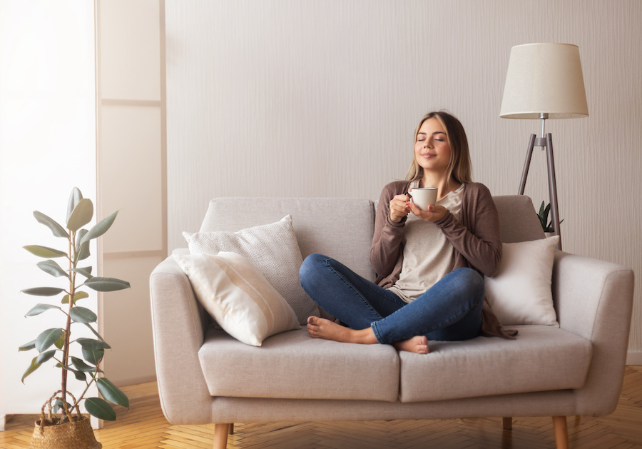 woman drinking coffee on couch