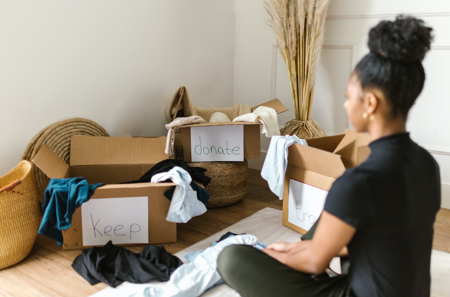 woman sitting in front of boxes in room